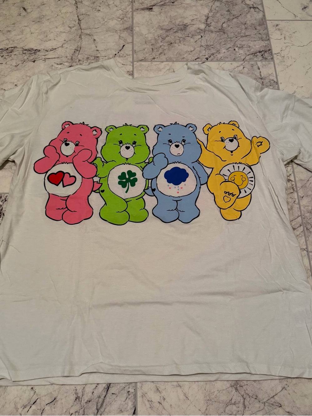 Care Bears Graphic Tee in White with Pink, Green, Blue & Yellow Bears
